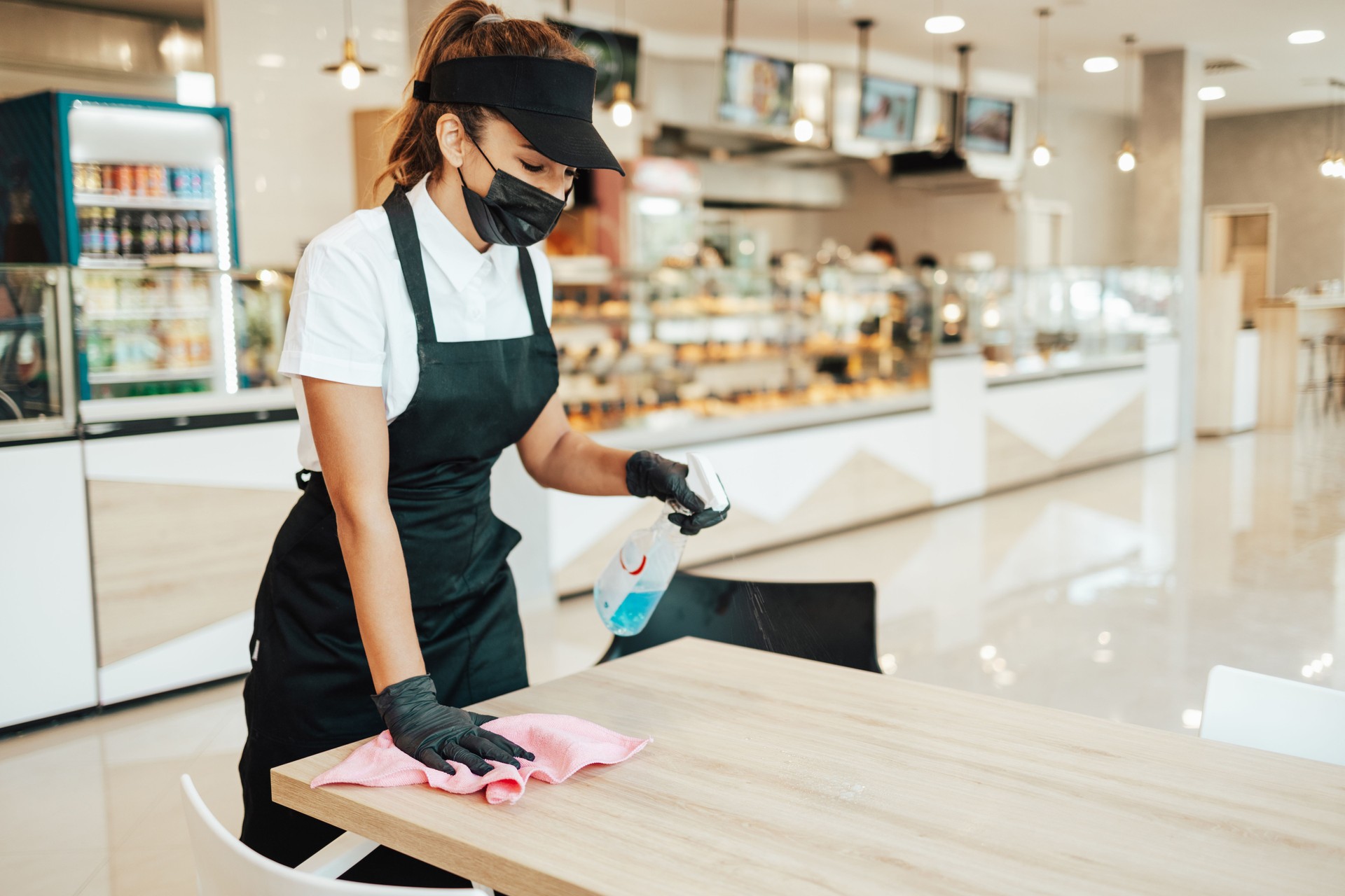 Young beautiful woman working in a bakery